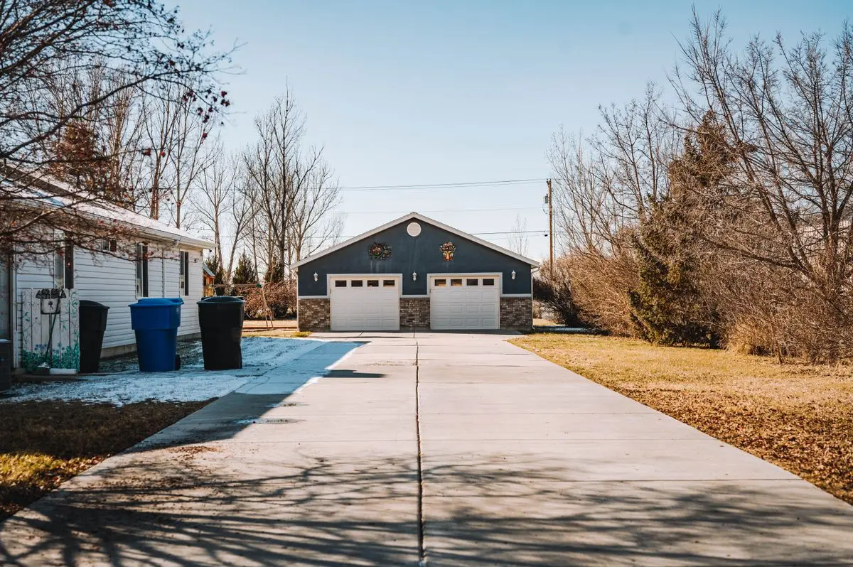 Suburban driveway leading up to a house and garage
